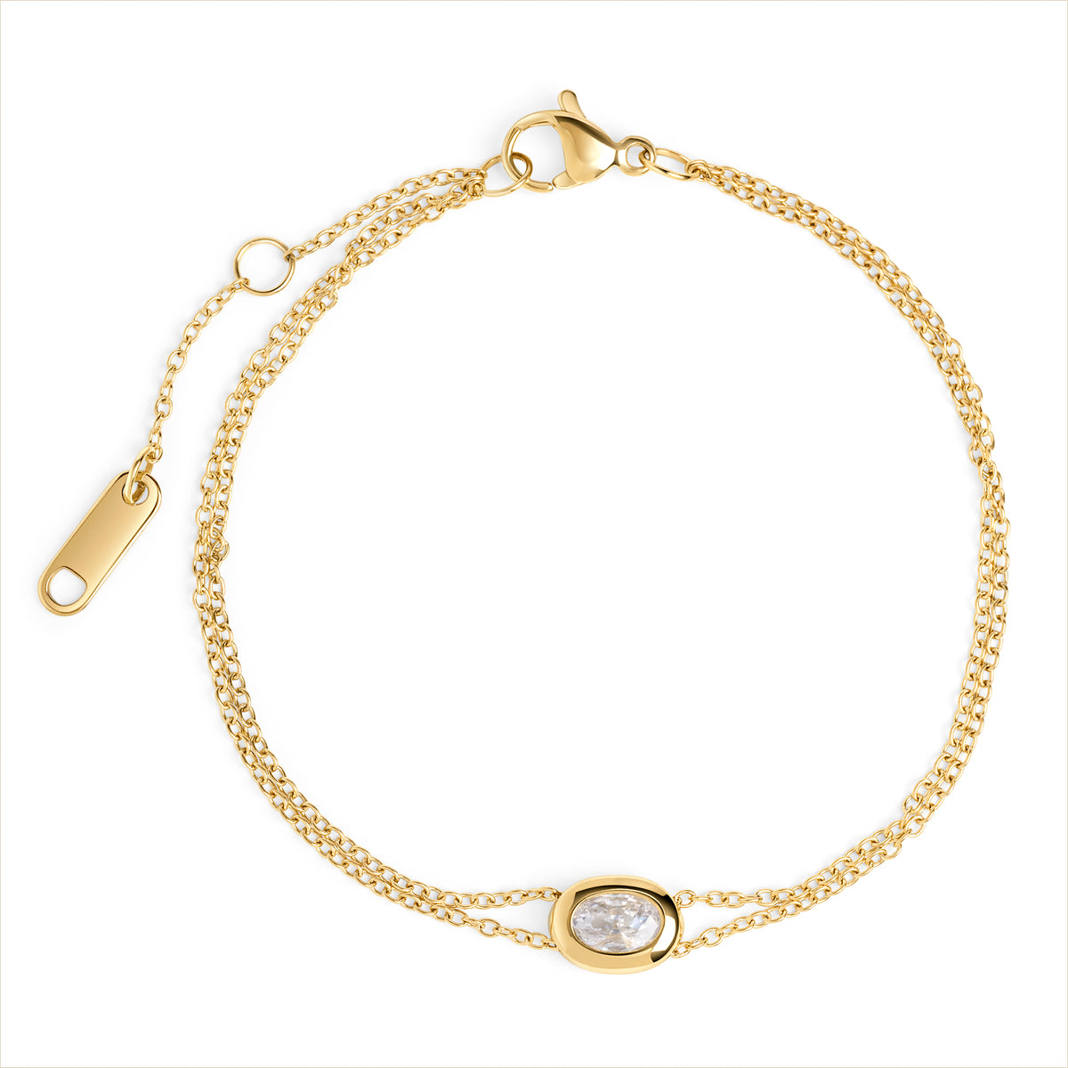 A double gold chain bracelet with an oval clear stone centerpiece, shown on a clean white background. Waterproof, stainless steel and allergy free. By Mia Bijoux Canada.

Bracelet à double chaîne dorée orné d'une pierre transparente ovale en son centre, présenté sur fond blanc épuré. Résistant à l'eau, en acier inoxydable et hypoallergénique. Par Mia Bijoux Canada.